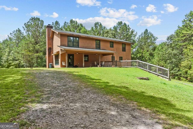 225 Big Oconee River Rd, Sparta, GA 31087 - rear view of property featuring a yard and a chimney