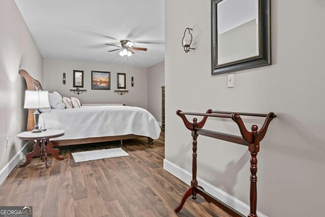 225 Big Oconee River Rd, Sparta, GA 31087 - bedroom with ceiling fan, baseboards, and wood finished floors