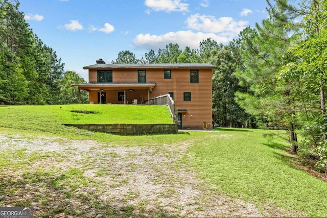 225 Big Oconee River Rd, Sparta, GA 31087 - rear view of house with a lawn and a chimney