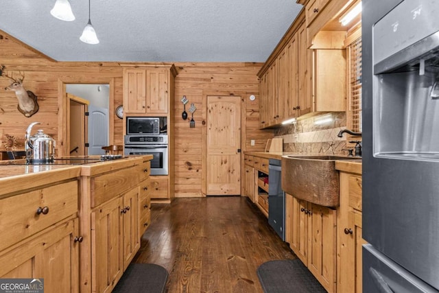 225 Big Oconee River Rd, Sparta, GA 31087 - kitchen featuring a sink, wooden walls, stainless steel oven, and dark wood-style flooring