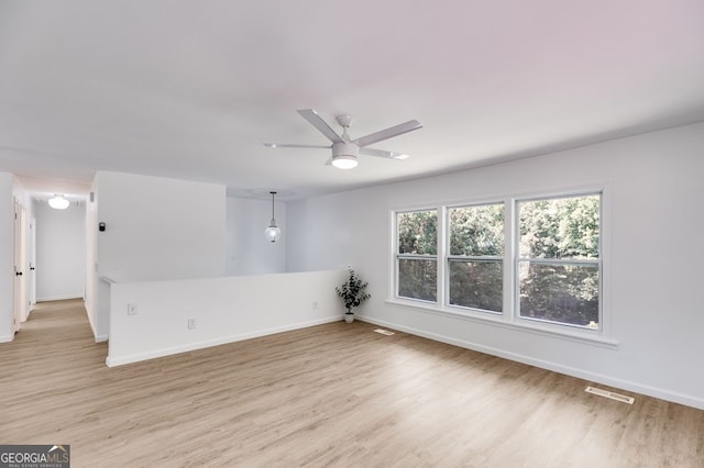 unfurnished room featuring ceiling fan and light wood-type flooring