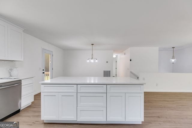 kitchen with light hardwood / wood-style flooring, stainless steel dishwasher, hanging light fixtures, and white cabinetry