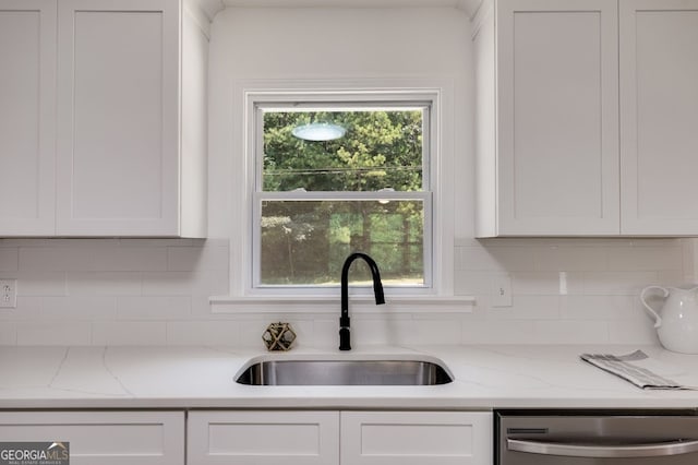 kitchen featuring sink, a wealth of natural light, stainless steel dishwasher, and white cabinets