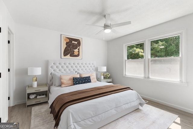 bedroom with ceiling fan and light wood-type flooring