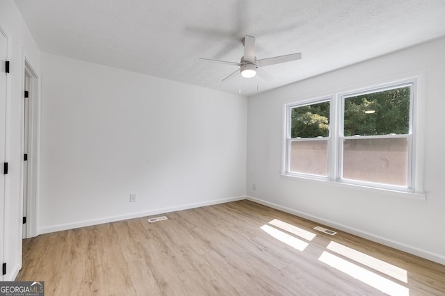 spare room featuring light hardwood / wood-style flooring and ceiling fan