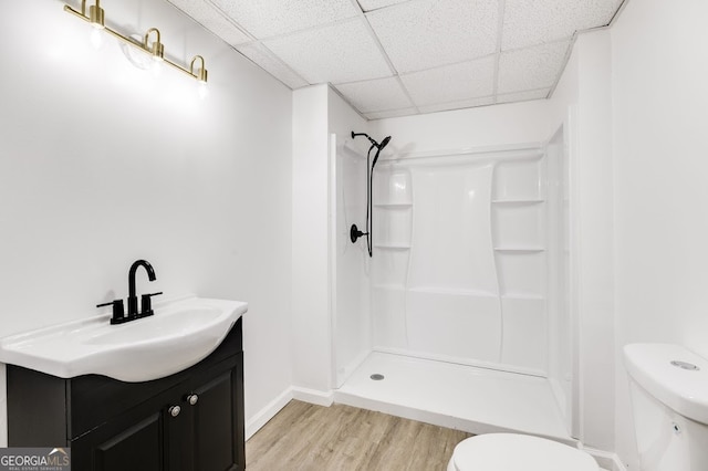 bathroom with walk in shower, toilet, vanity, and wood-type flooring