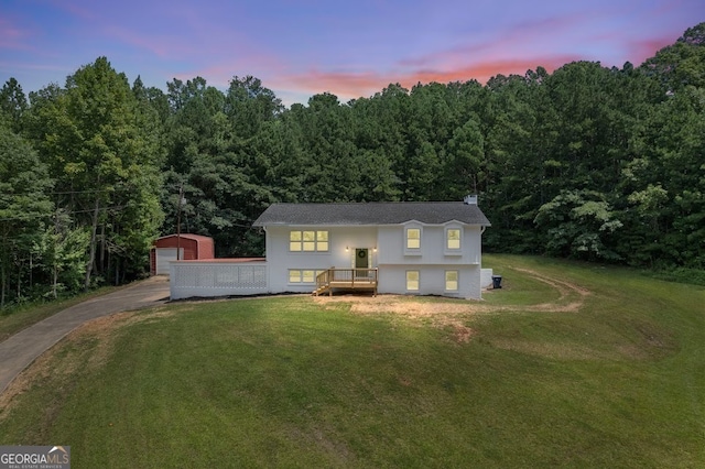 raised ranch featuring a yard and a wooden deck