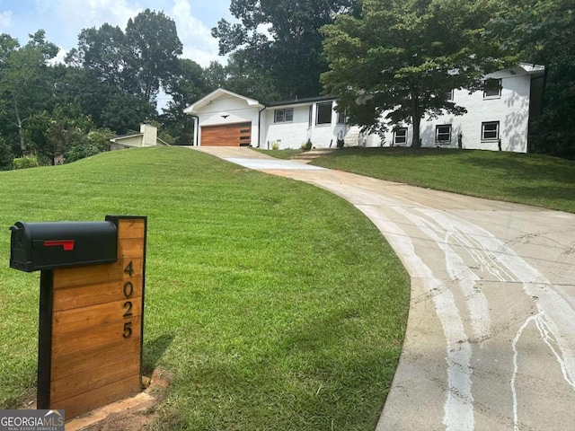 view of front of house with a front yard and a garage