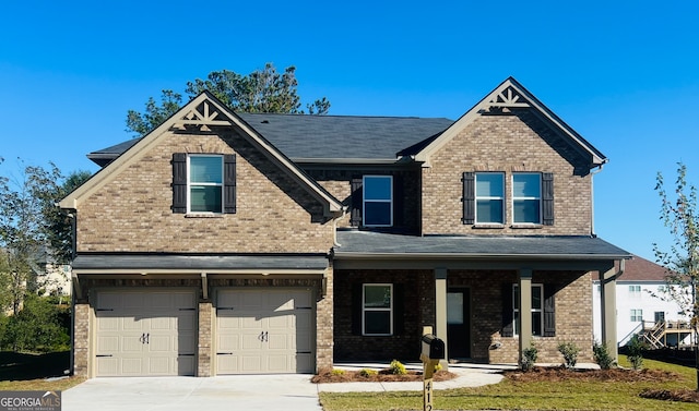 craftsman-style house featuring covered porch and a garage