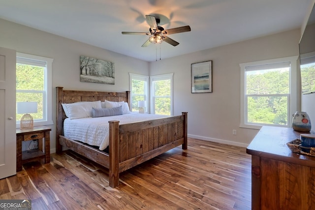 bedroom with ceiling fan and hardwood / wood-style flooring