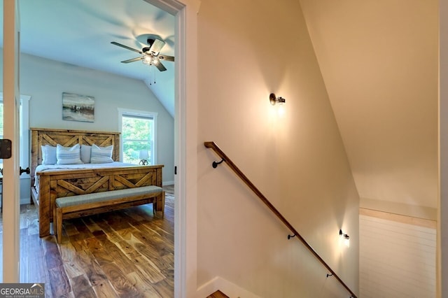 bedroom featuring ceiling fan, lofted ceiling, and hardwood / wood-style floors