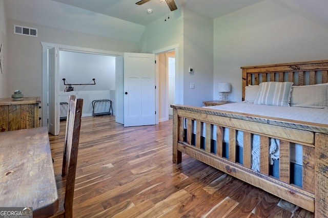 bedroom with hardwood / wood-style floors, vaulted ceiling, and ceiling fan