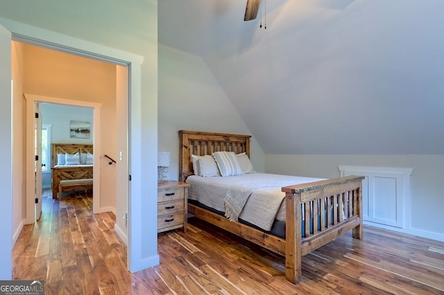 bedroom featuring lofted ceiling, wood finished floors, a ceiling fan, and baseboards