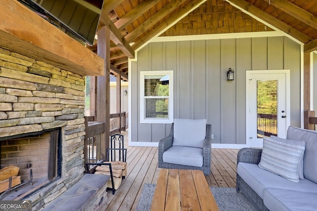 wooden terrace featuring a fireplace