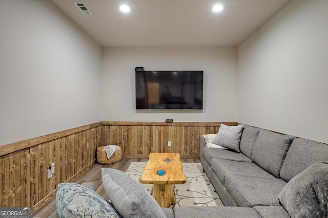 living room featuring wood walls and light hardwood / wood-style floors