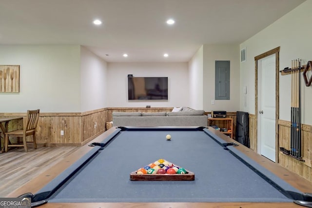 rec room with a wainscoted wall, recessed lighting, visible vents, wood finished floors, and electric panel