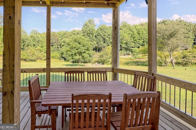 wooden terrace featuring a yard