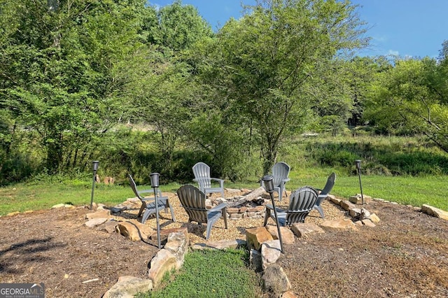 view of yard with an outdoor fire pit