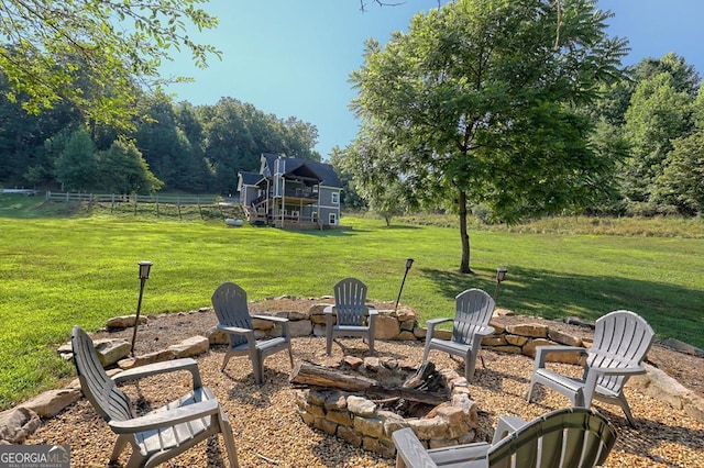 view of patio with fence and a fire pit