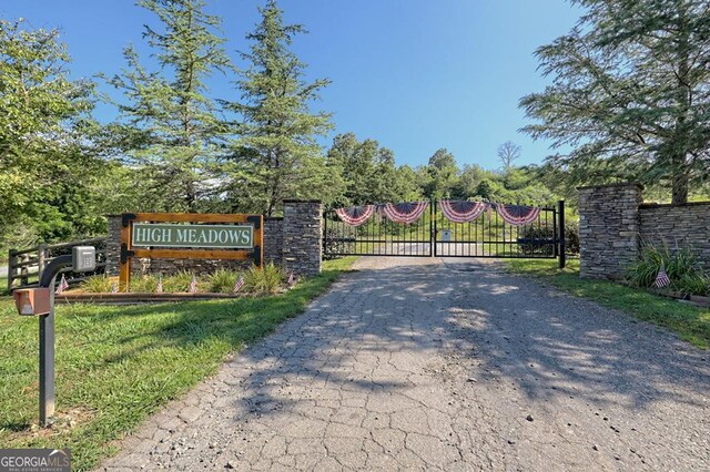 view of gate with a yard