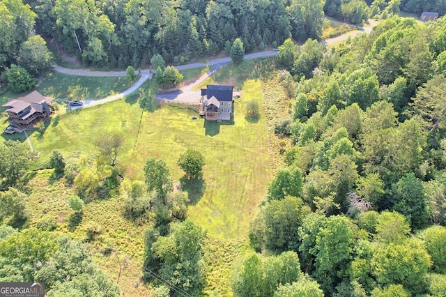 bird's eye view featuring a wooded view