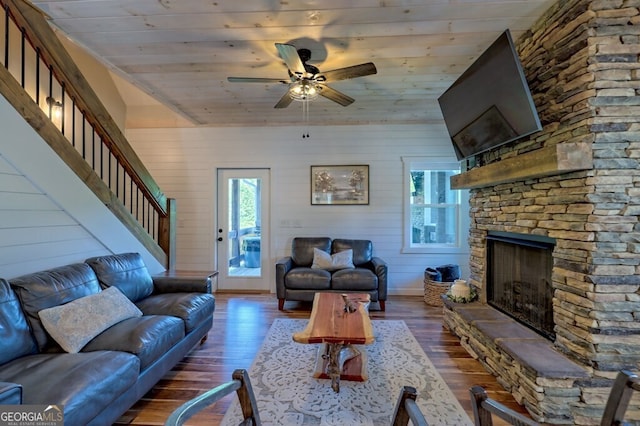 unfurnished living room with ceiling fan, wooden ceiling, and dark wood-type flooring