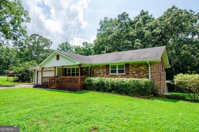 single story home with a garage, a front yard, and covered porch