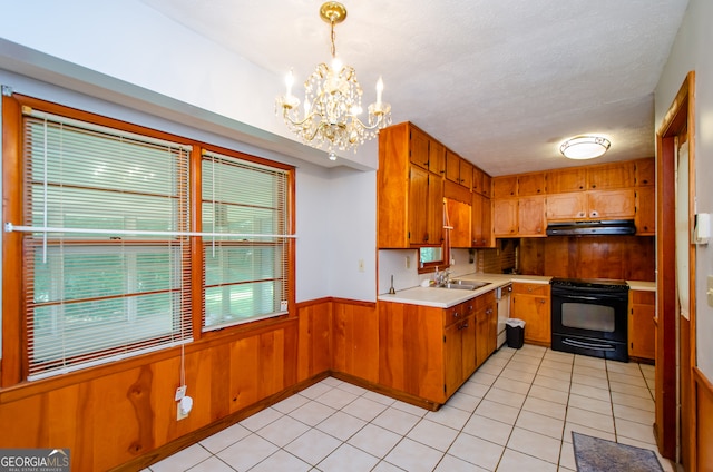 kitchen with dishwasher, a notable chandelier, light tile patterned floors, electric range, and sink