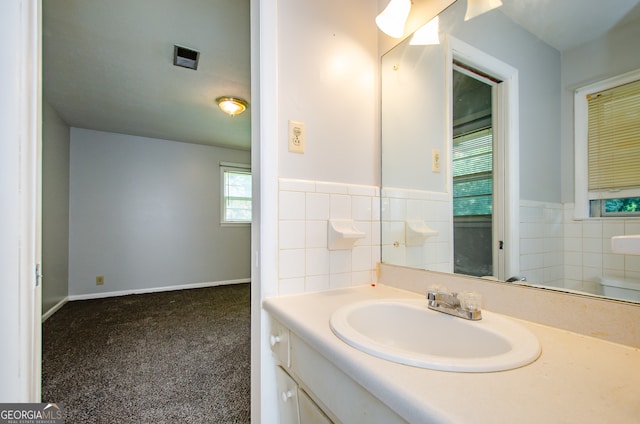 bathroom with tile walls, tasteful backsplash, and vanity