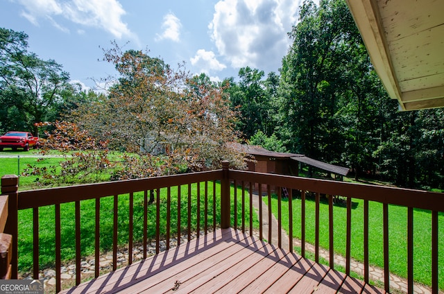 wooden deck featuring a yard