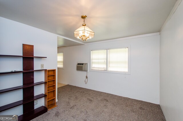 interior space with a notable chandelier, a wall mounted air conditioner, ornamental molding, and carpet floors