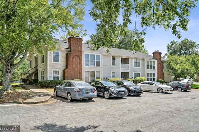 view of building exterior featuring uncovered parking