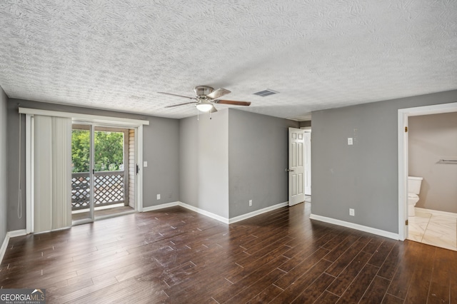 interior space with baseboards, visible vents, ceiling fan, dark wood-style flooring, and a textured ceiling