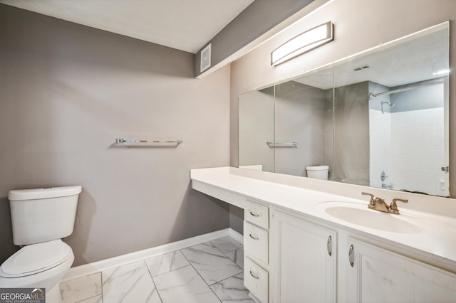 bathroom featuring toilet, vanity, baseboards, marble finish floor, and walk in shower