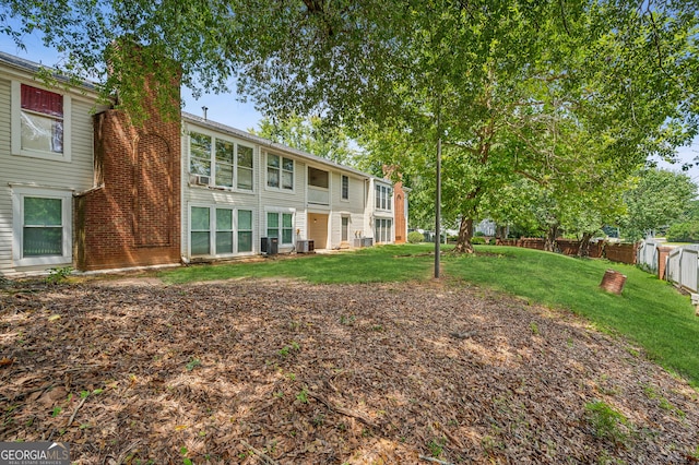 view of yard with fence and central AC unit