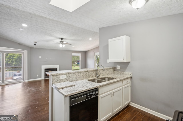 kitchen with a peninsula, a sink, white cabinets, black dishwasher, and open floor plan