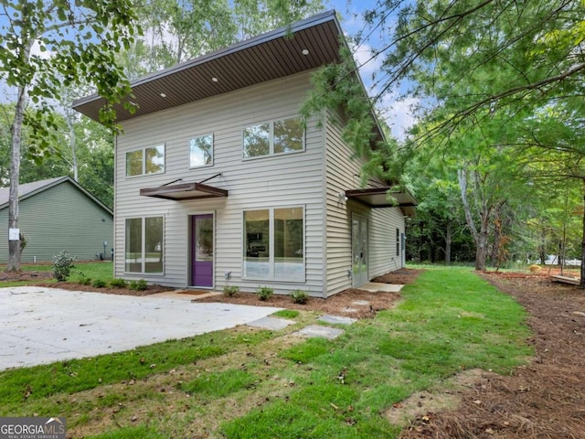 front facade featuring a front lawn and a patio