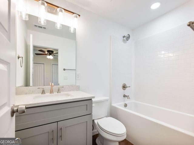 full bathroom with vanity, ceiling fan, tiled shower / bath, and toilet