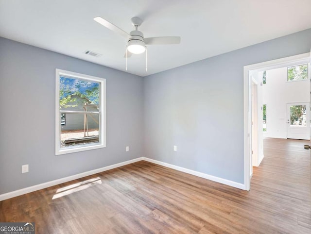 spare room featuring light hardwood / wood-style flooring and ceiling fan