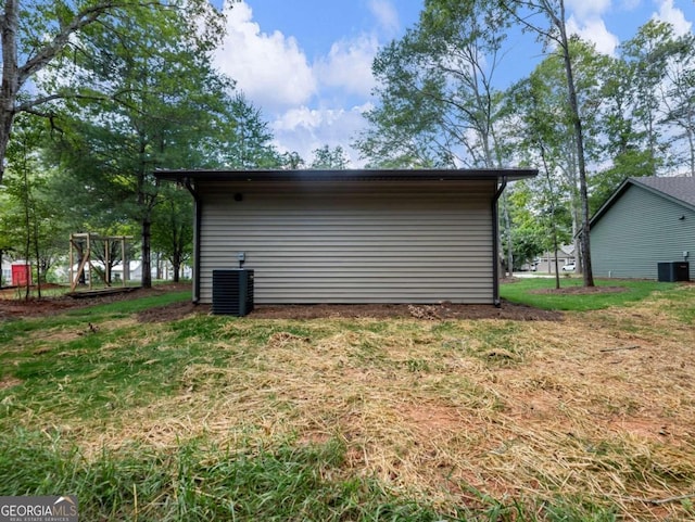 exterior space with a lawn and central AC