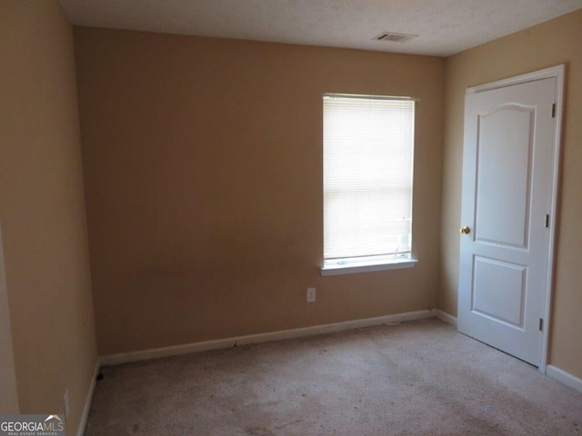 spare room with light carpet