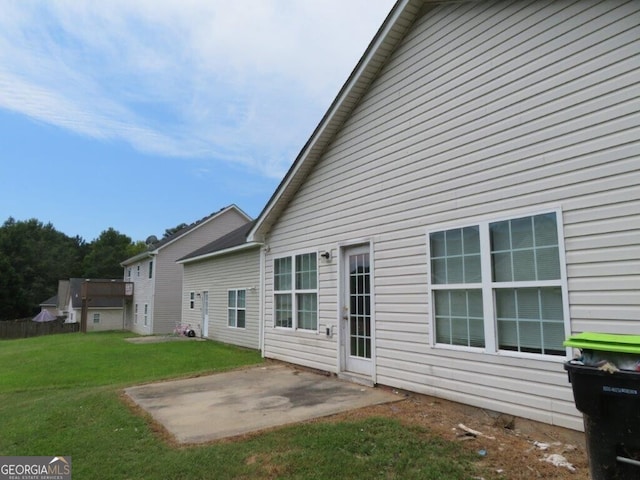 back of property featuring a lawn and a patio