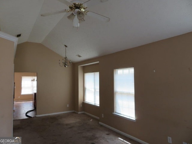 carpeted empty room featuring lofted ceiling and ceiling fan with notable chandelier