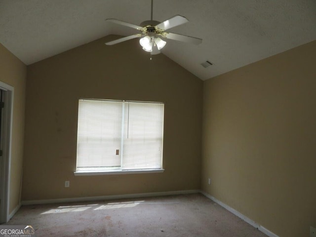 carpeted spare room with lofted ceiling and ceiling fan