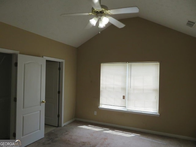 unfurnished bedroom featuring light carpet, lofted ceiling, and ceiling fan