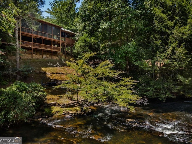 exterior space with a deck with water view