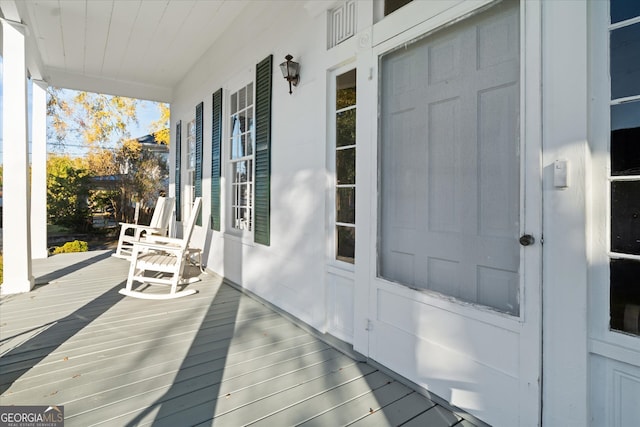 wooden terrace featuring a porch