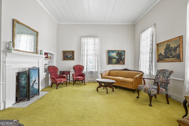 sitting room featuring ornamental molding, light carpet, and a tile fireplace