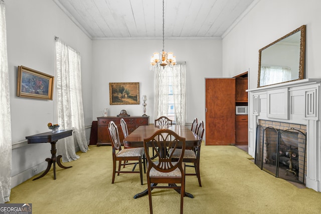 carpeted dining space featuring wooden ceiling, ornamental molding, a chandelier, and a fireplace