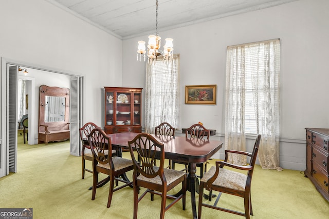 dining space featuring light carpet, a notable chandelier, and plenty of natural light